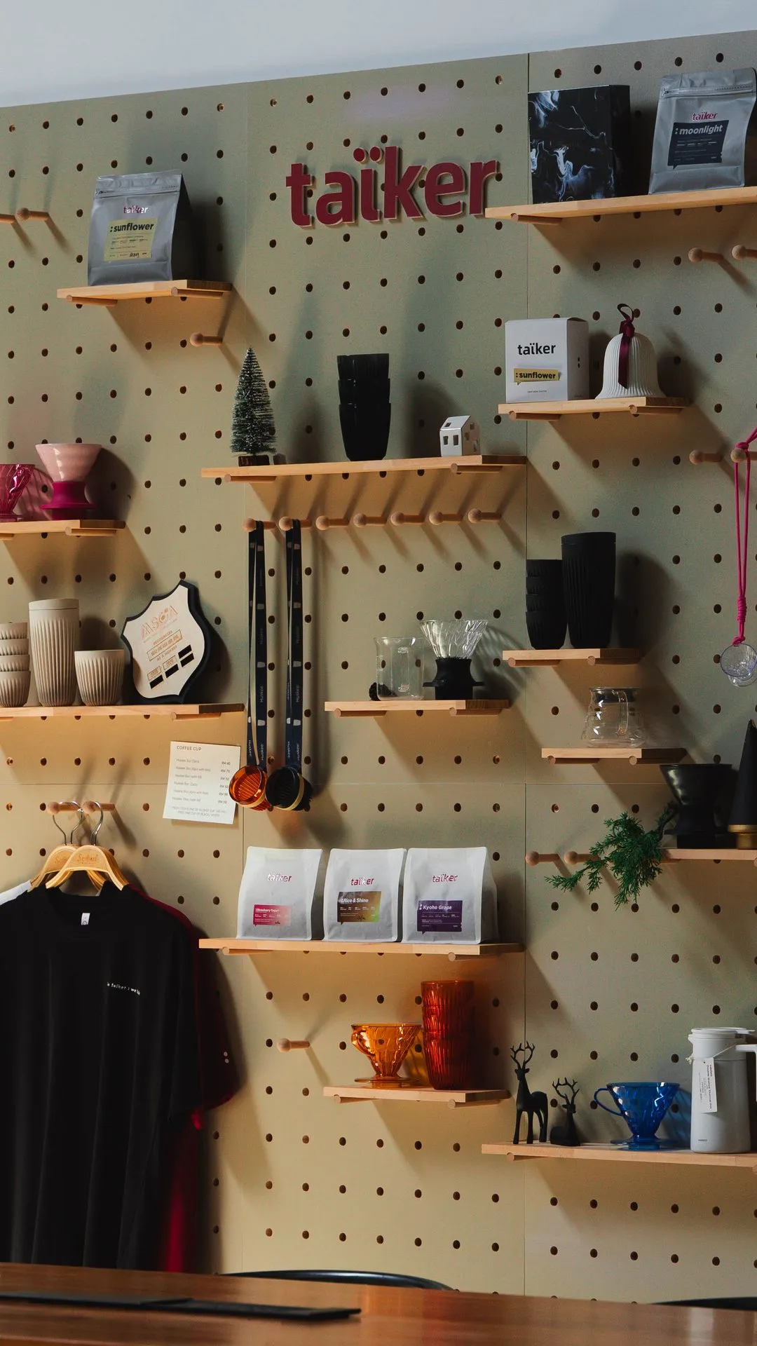 taïker retail wall — whole bean, drip bag and accessories on display
