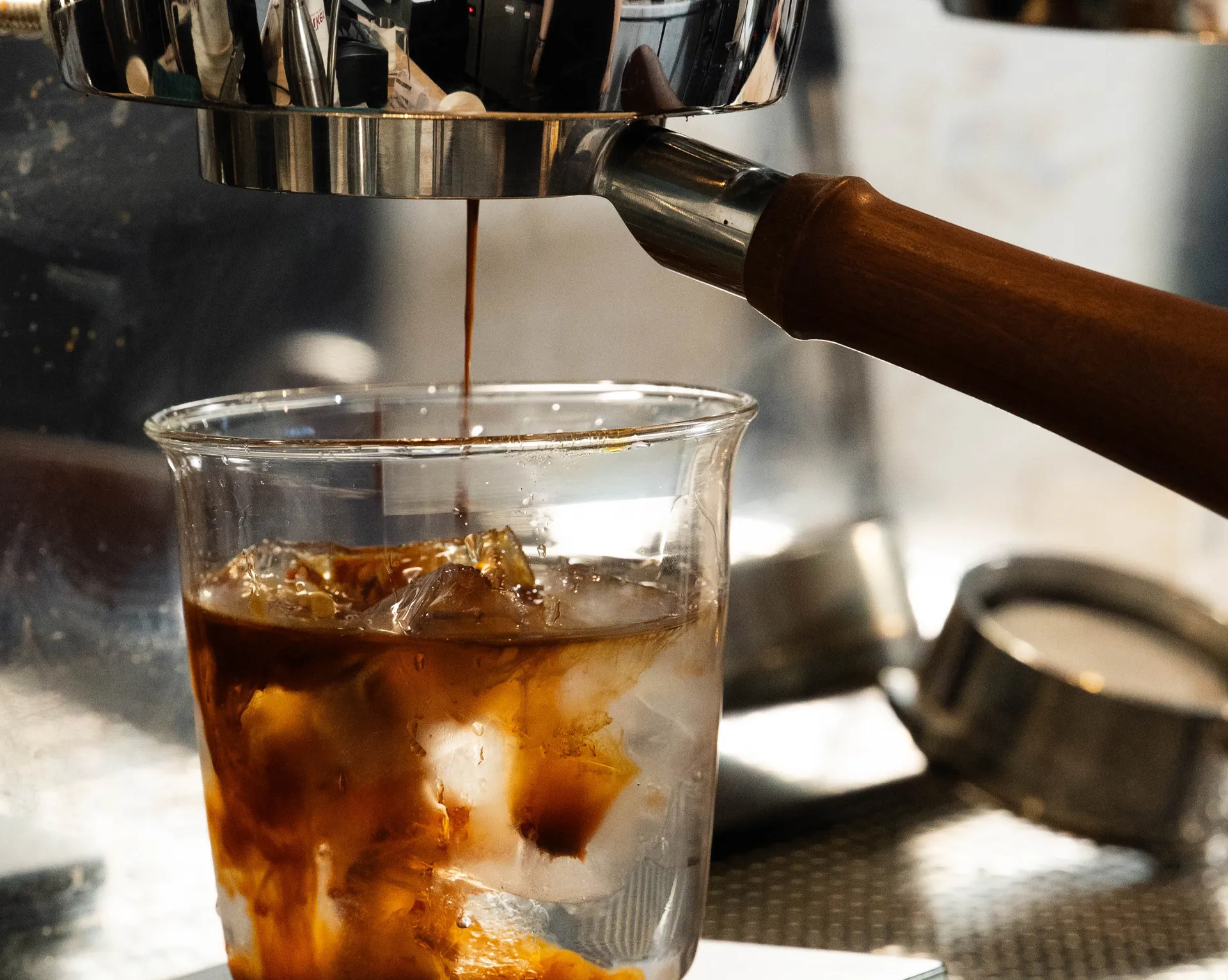 Espresso pouring over ice on a precision scale